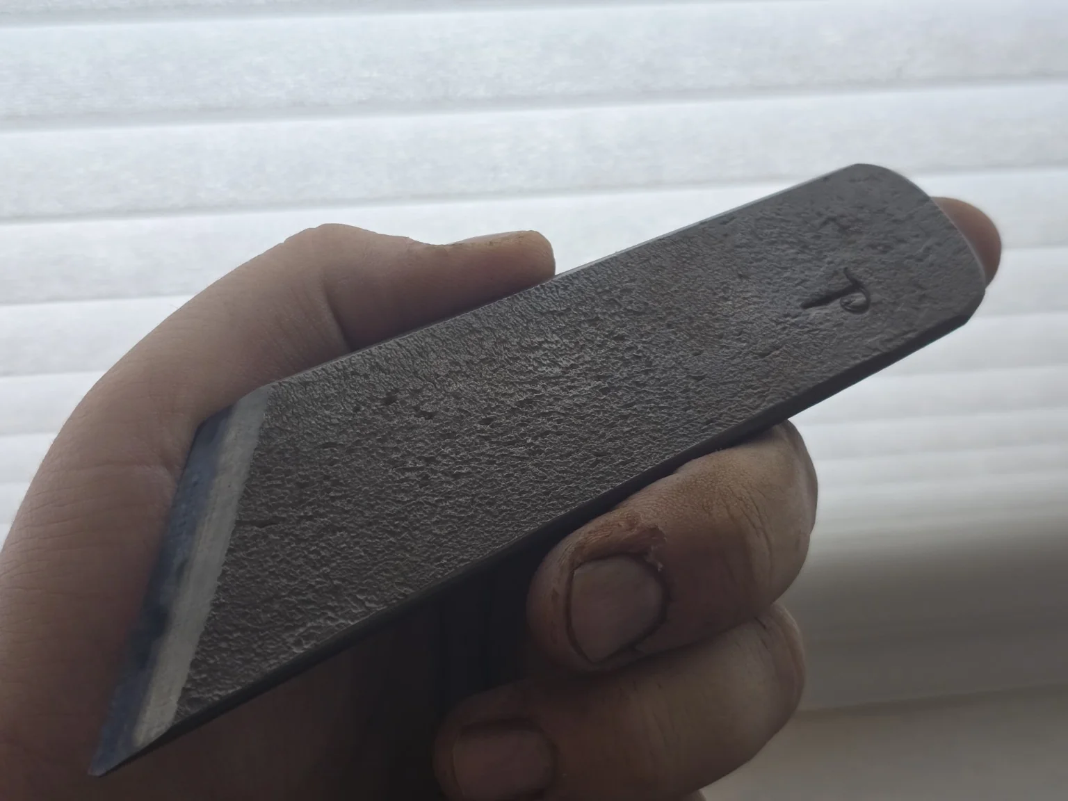 Forged steel surface held in hand